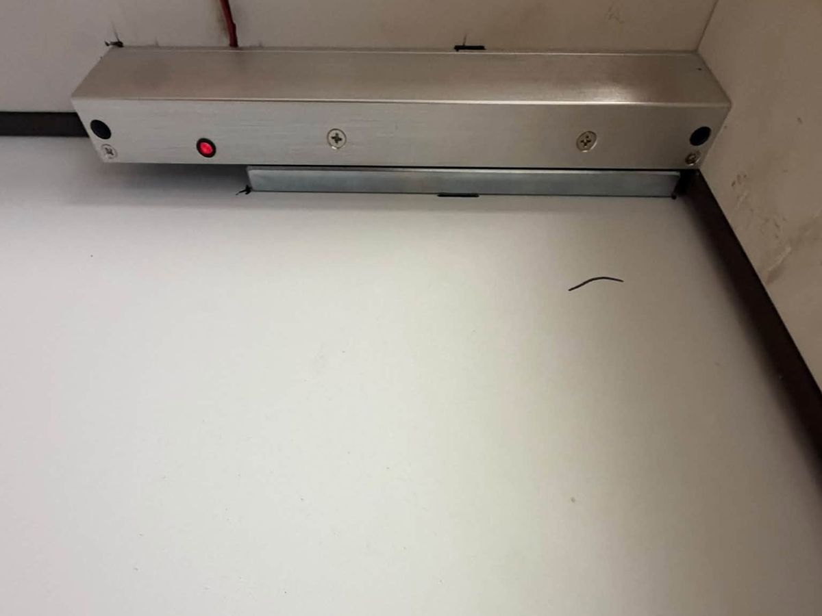 Mag lock mounted on a door frame