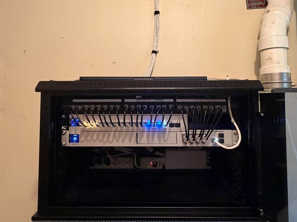 Wall-mounted network rack installed by Ultimate Solutions